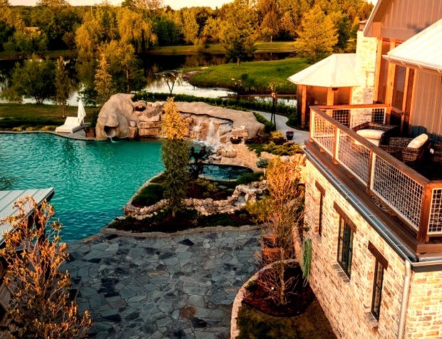 Huge farmhouse backyard stone and custom-shaped natural and privacy pool photo