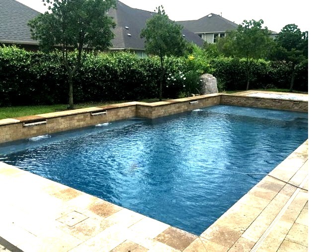 Photo of a large, modern backyard fountain with a rectangular natural pool