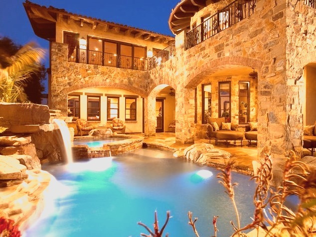 A medium-sized tuscan backyard with a uniquely shaped hot tub