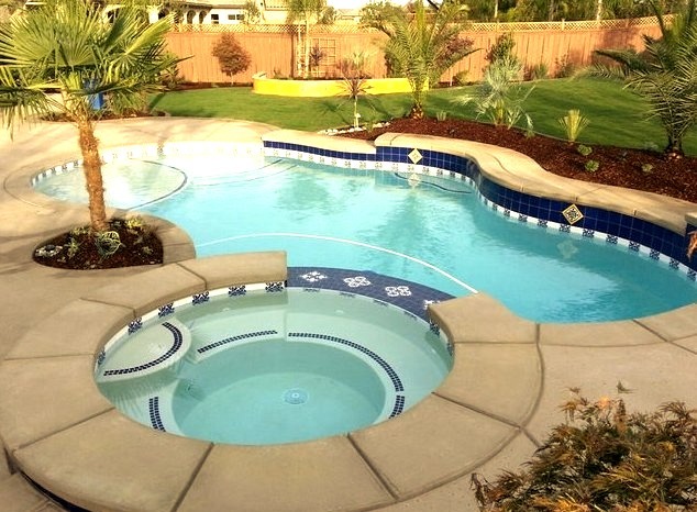 Small Mediterranean backyard concrete and natural hot tub design idea